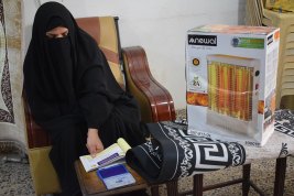 فرع النجف :-  تسليم الاعانه لاسره السيدة / فليحه . ع . ع من السيده / عاليه جواد 